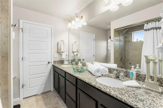 18651 E 53rd Ave, Denver, CO 80249 - bathroom featuring tiled shower and double vanity