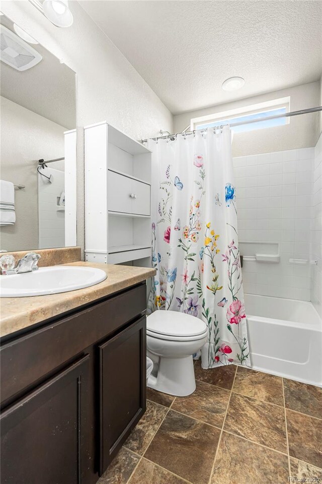 18651 E 53rd Ave, Denver, CO 80249 - bathroom with vanity, a textured ceiling, shower / bath combo, toilet, and stone finish flooring