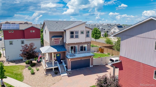 18651 E 53rd Ave, Denver, CO 80249 - back of house with a residential view, decorative driveway, roof with shingles, and an attached garage