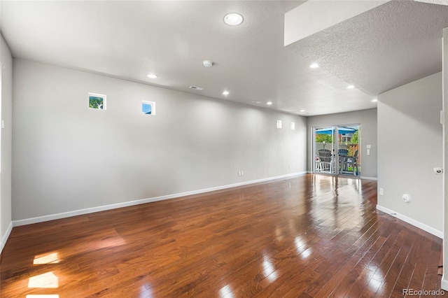 18651 E 53rd Ave, Denver, CO 80249 - spare room featuring hardwood / wood-style flooring, baseboards, recessed lighting, and a textured ceiling