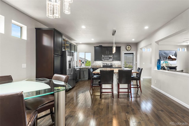 18651 E 53rd Ave, Denver, CO 80249 - dining room featuring dark wood-type flooring, a chandelier, recessed lighting, and baseboards