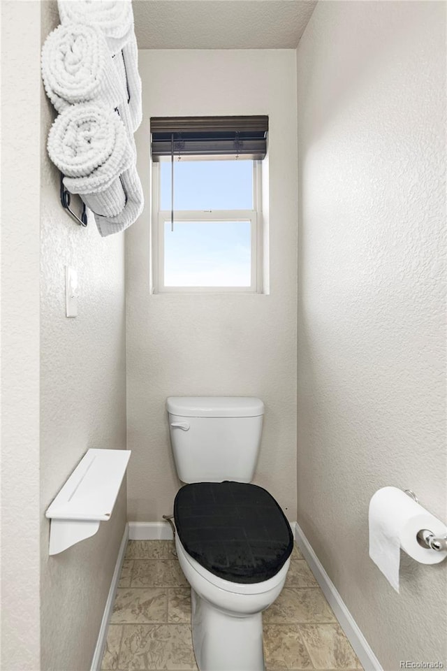 18651 E 53rd Ave, Denver, CO 80249 - bathroom with toilet and baseboards