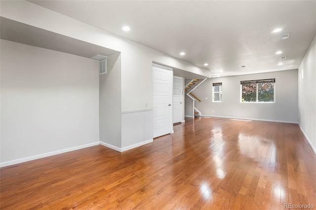 18651 E 53rd Ave, Denver, CO 80249 - unfurnished living room with stairway, wood-type flooring, recessed lighting, and baseboards