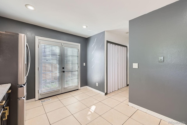 3320 Simmelink Loop, Colorado Springs, CO 80916 - kitchen with freestanding refrigerator, healthy amount of natural light, light tile patterned floors, and baseboards