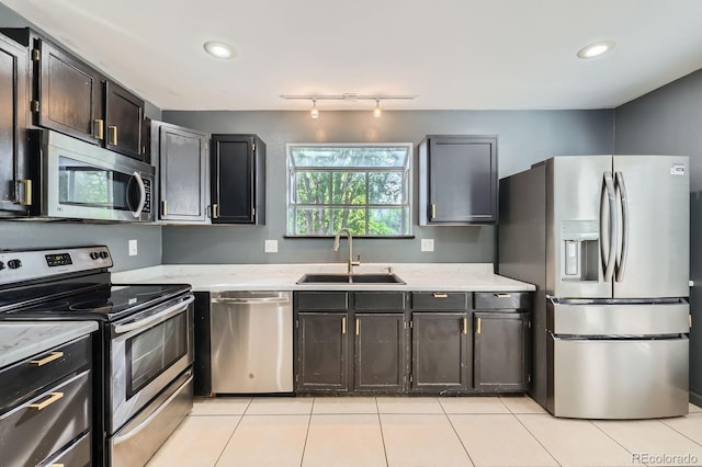 3320 Simmelink Loop, Colorado Springs, CO 80916 - kitchen featuring stainless steel appliances, a sink, light tile patterned floors, light stone counters, and recessed lighting