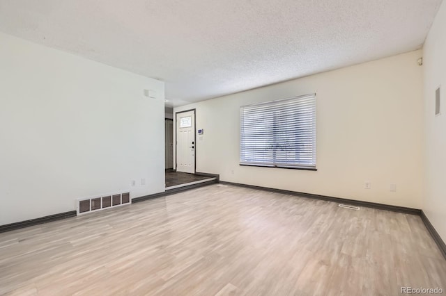 3320 Simmelink Loop, Colorado Springs, CO 80916 - unfurnished room with wood finished floors, baseboards, and a textured ceiling