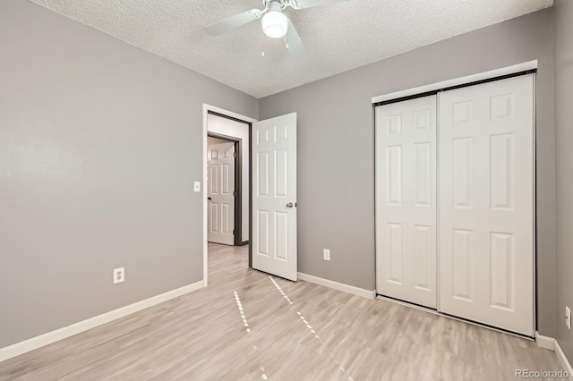 3320 Simmelink Loop, Colorado Springs, CO 80916 - unfurnished bedroom featuring light wood-type flooring, baseboards, a textured ceiling, a closet, and a ceiling fan