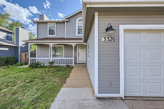 3320 Simmelink Loop, Colorado Springs, CO 80916 - view of front facade with a porch, a chimney, and a garage