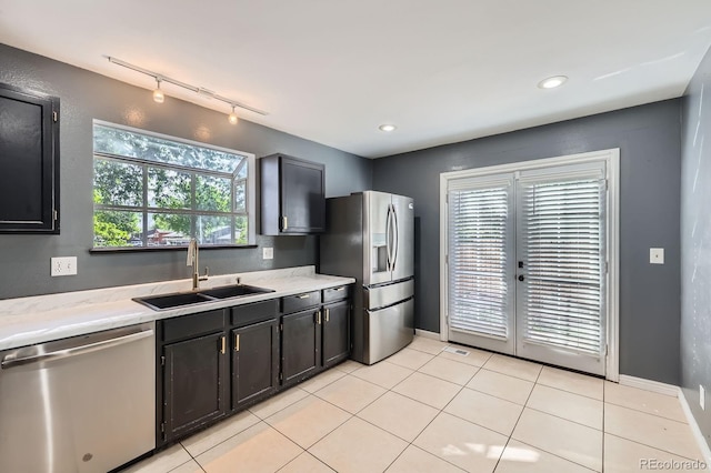 3320 Simmelink Loop, Colorado Springs, CO 80916 - kitchen featuring appliances with stainless steel finishes, a sink, rail lighting, light tile patterned floors, and baseboards