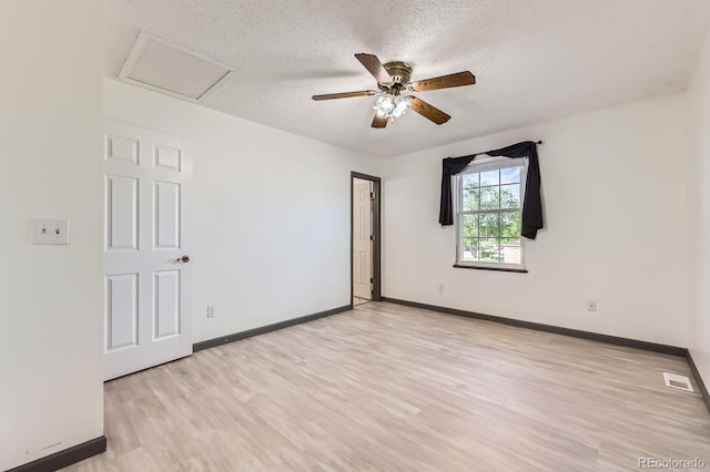 3320 Simmelink Loop, Colorado Springs, CO 80916 - unfurnished room featuring a textured ceiling, light wood-style floors, baseboards, attic access, and ceiling fan