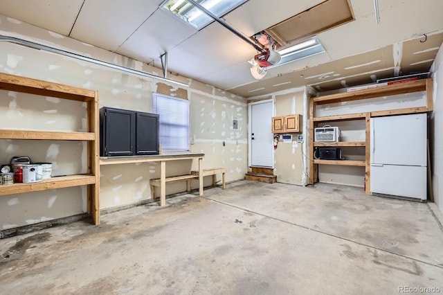 3320 Simmelink Loop, Colorado Springs, CO 80916 - garage with freestanding refrigerator and a garage door opener
