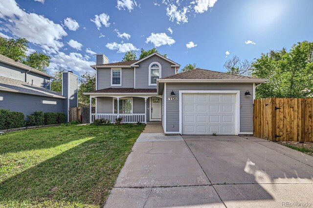 3320 Simmelink Loop, Colorado Springs, CO 80916 - traditional home with a porch, an attached garage, driveway, and a chimney
