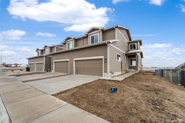 view of front of home with central air condition unit and a garage