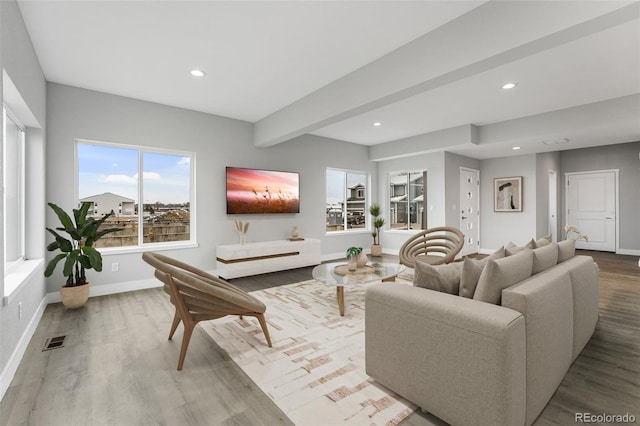 living room featuring beamed ceiling and wood-type flooring