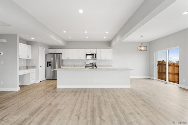 kitchen featuring white cabinets, light wood-type flooring, and appliances with stainless steel finishes