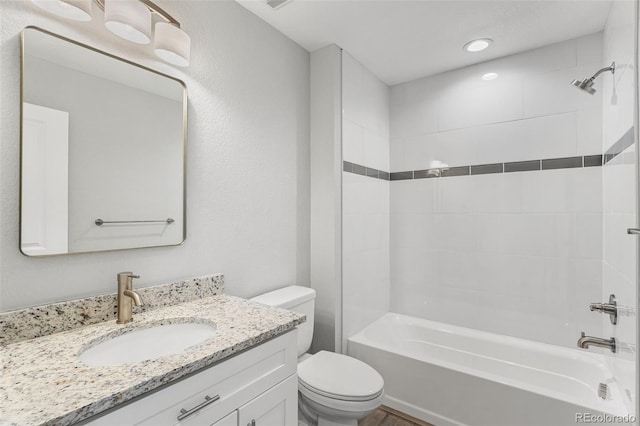 full bathroom featuring vanity, toilet, and tiled shower / bath