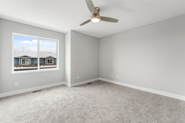 spare room featuring carpet flooring and ceiling fan