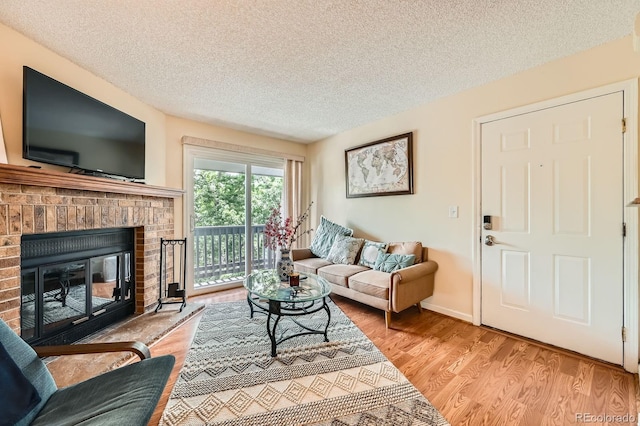 7881 Allison Way Unit 303, Arvada, CO 80005 - living area featuring a textured ceiling, wood finished floors, and a fireplace