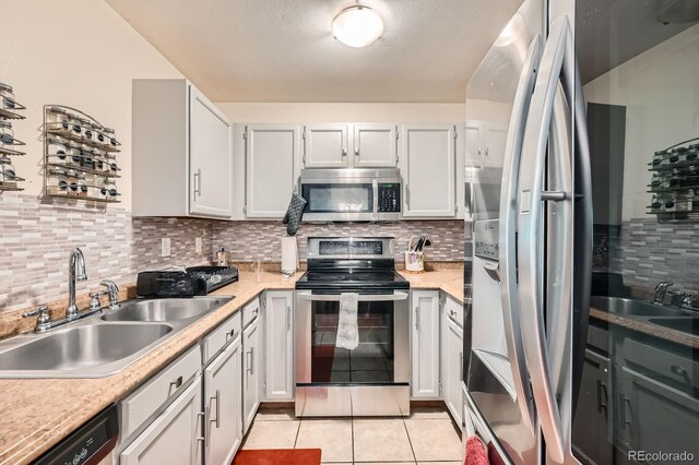 7881 Allison Way Unit 303, Arvada, CO 80005 - kitchen with stainless steel appliances, decorative backsplash, light countertops, and light tile patterned flooring