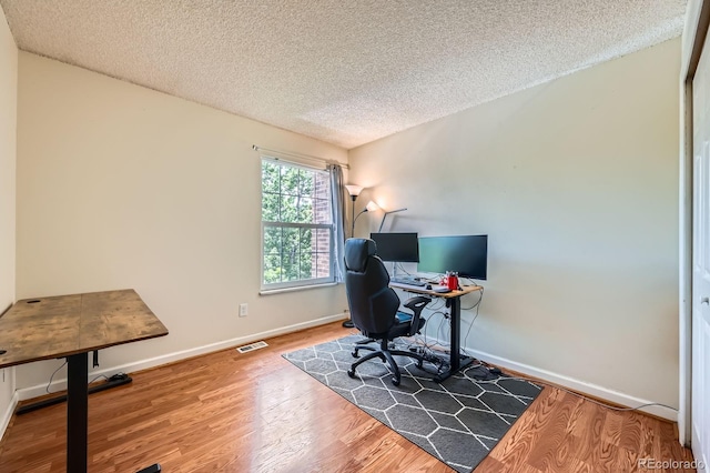 7881 Allison Way Unit 303, Arvada, CO 80005 - home office with a textured ceiling and wood finished floors