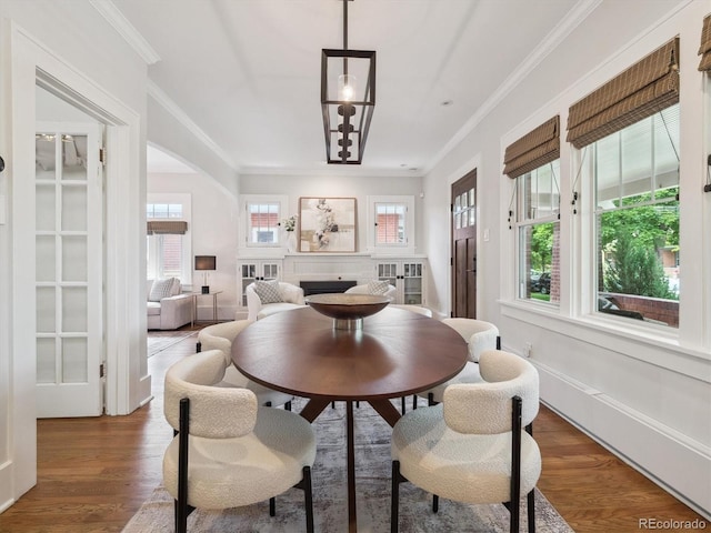 660 S Clarkson St, Denver, CO 80209 - dining room with a fireplace, crown molding, and wood finished floors