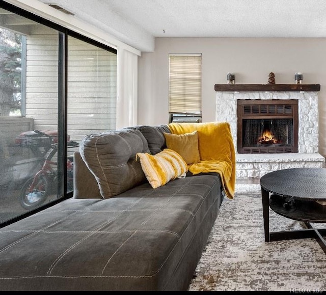 16001 E Alaska Pl Unit 12, Aurora, CO 80017 - living room with plenty of natural light, a fireplace, and a textured ceiling