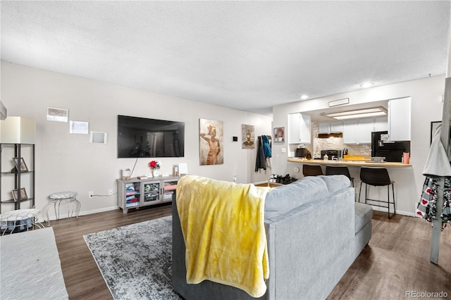 16001 E Alaska Pl Unit 12, Aurora, CO 80017 - living area featuring dark wood-style floors, a textured ceiling, and recessed lighting