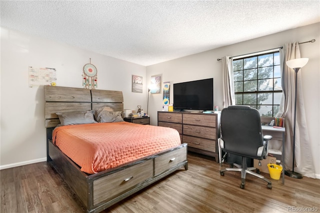 16001 E Alaska Pl Unit 12, Aurora, CO 80017 - bedroom with wood finished floors, a textured ceiling, and an office area