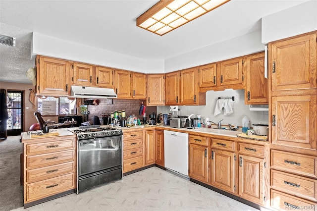 kitchen featuring range hood, gas stove, white dishwasher, a sink, and light countertops