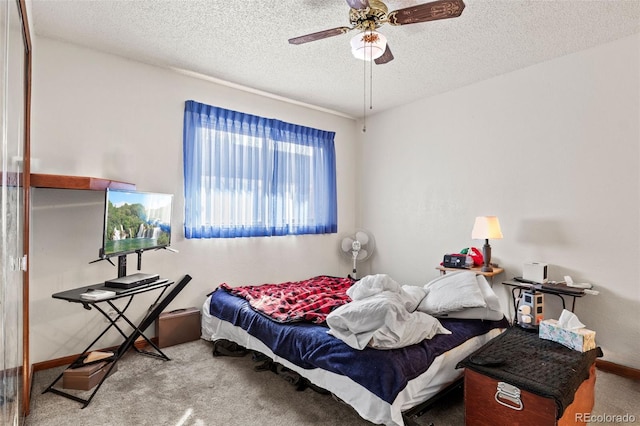 bedroom with carpet floors, a textured ceiling, and ceiling fan