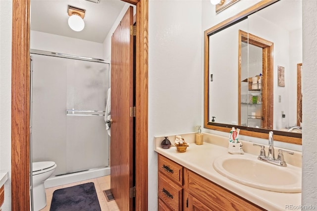 full bathroom featuring toilet, a stall shower, and vanity