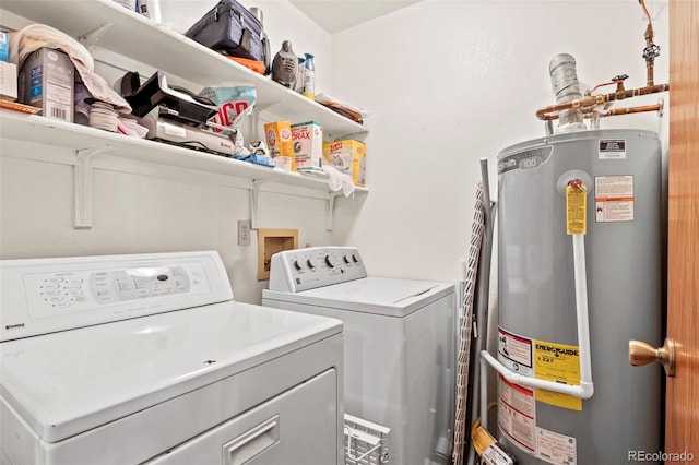 laundry area featuring water heater, laundry area, and independent washer and dryer