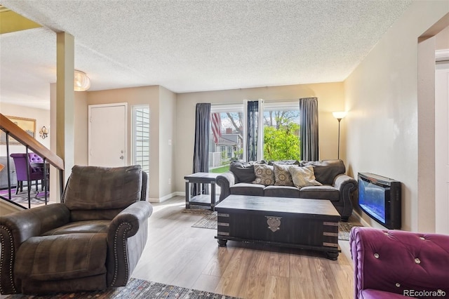 7925 W Layton Ave Unit 500, Littleton, CO 80123 - living room featuring a textured ceiling, wood finished floors, and baseboards