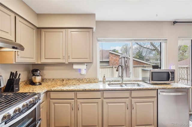 7925 W Layton Ave Unit 500, Littleton, CO 80123 - kitchen with appliances with stainless steel finishes, a sink, light stone counters, and under cabinet range hood