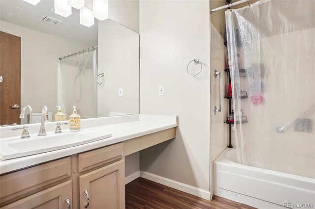 7925 W Layton Ave Unit 500, Littleton, CO 80123 - bathroom with baseboards, wood finished floors, vanity, and shower / bath combo with shower curtain