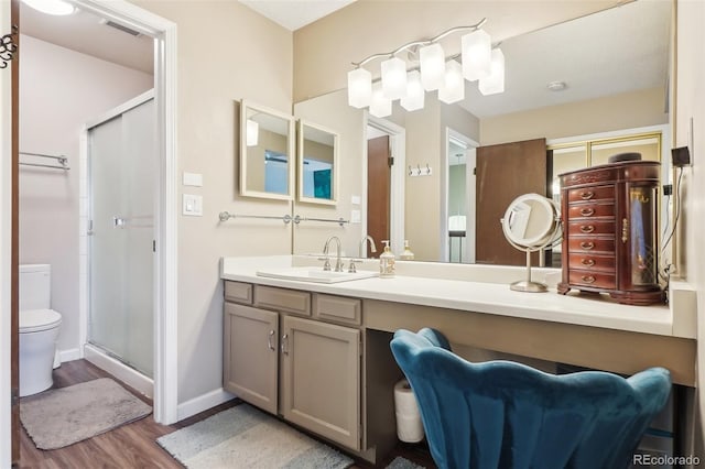 7925 W Layton Ave Unit 500, Littleton, CO 80123 - bathroom featuring wood finished floors, a shower stall, toilet, vanity, and baseboards