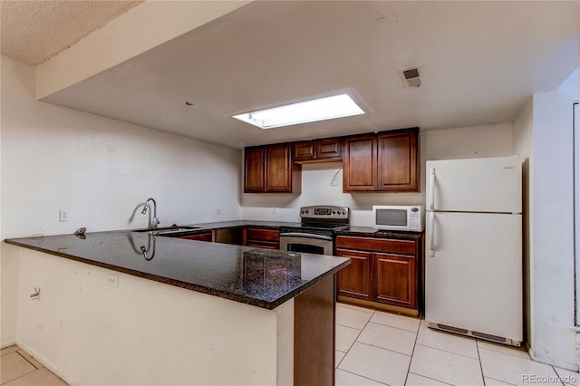 kitchen featuring sink, white appliances, kitchen peninsula, and light tile patterned floors