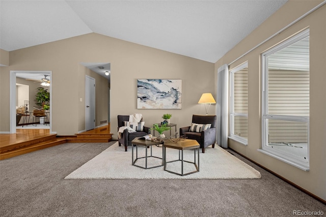 carpeted living room with lofted ceiling