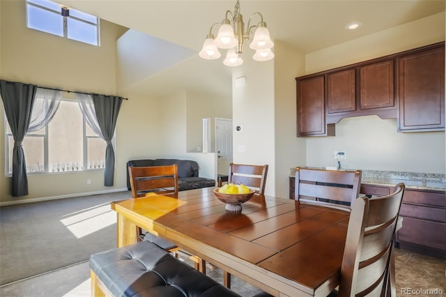 carpeted dining space featuring an inviting chandelier and a healthy amount of sunlight