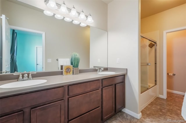 bathroom with vanity and shower / bath combination with glass door