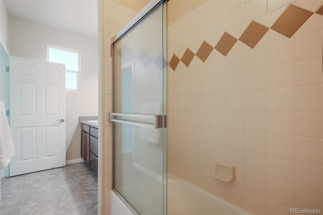 bathroom with vanity and combined bath / shower with glass door