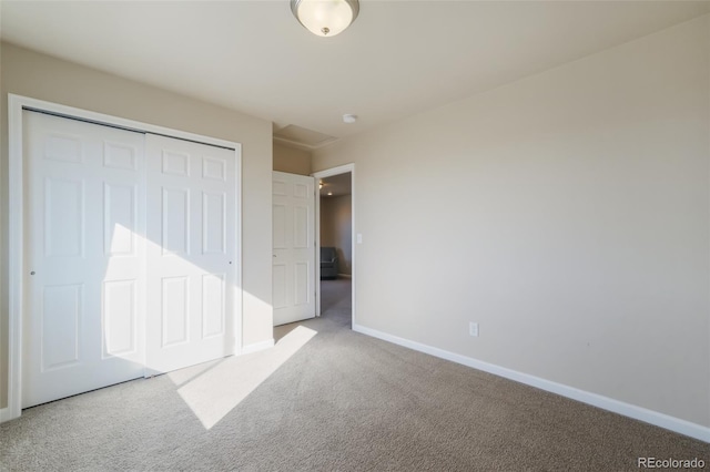 unfurnished bedroom with carpet flooring and a closet