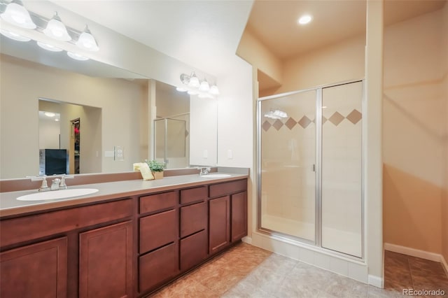 bathroom with vanity, tile patterned floors, and a shower with door