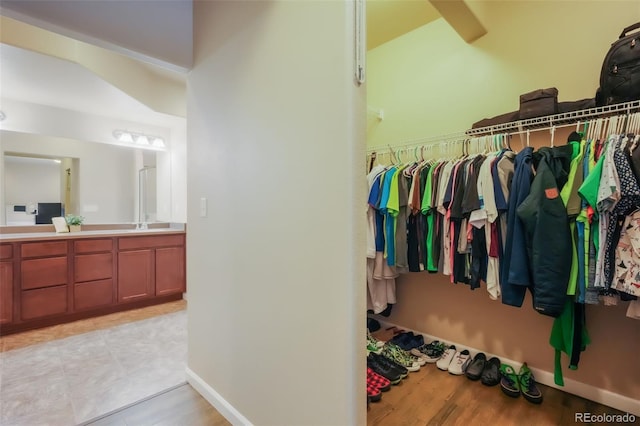 spacious closet featuring sink