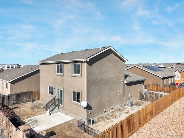 rear view of property featuring central AC unit and a patio