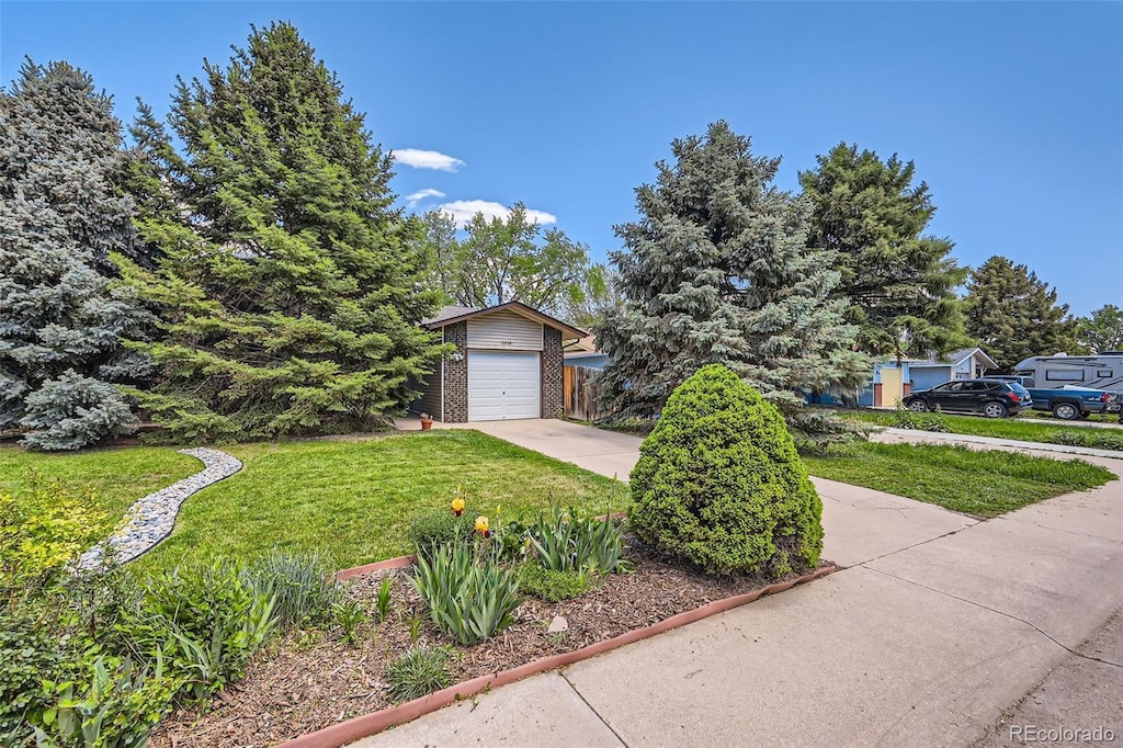 2208 Emery St, Longmont, CO 80501 - obstructed view of property featuring a front lawn and concrete driveway