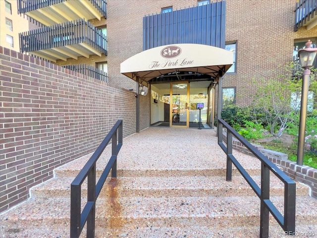 entrance to property featuring brick siding