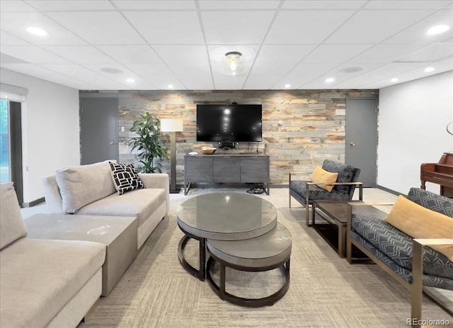 living area featuring a paneled ceiling, recessed lighting, and baseboards