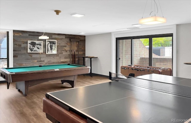 game room with billiards table, wood finished floors, an accent wall, and baseboards