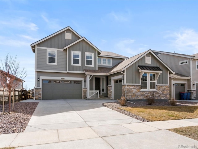 craftsman inspired home with stone siding, board and batten siding, and concrete driveway